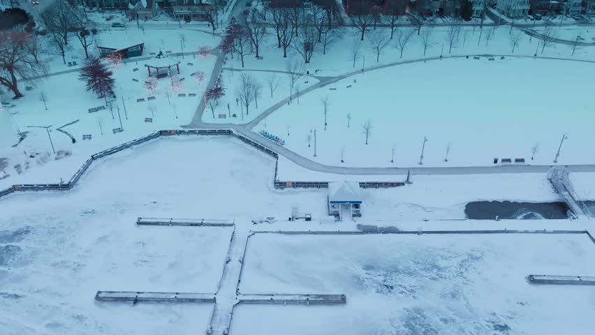 Snowy aerial view of Bronte Harbour and Lake Ontario in winter