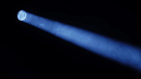 Blue spotlight beam illuminating dark stage, focusing on mysterious performance area - Powered by Shutterstock - Get 15% off with code: PIKWIZARD15