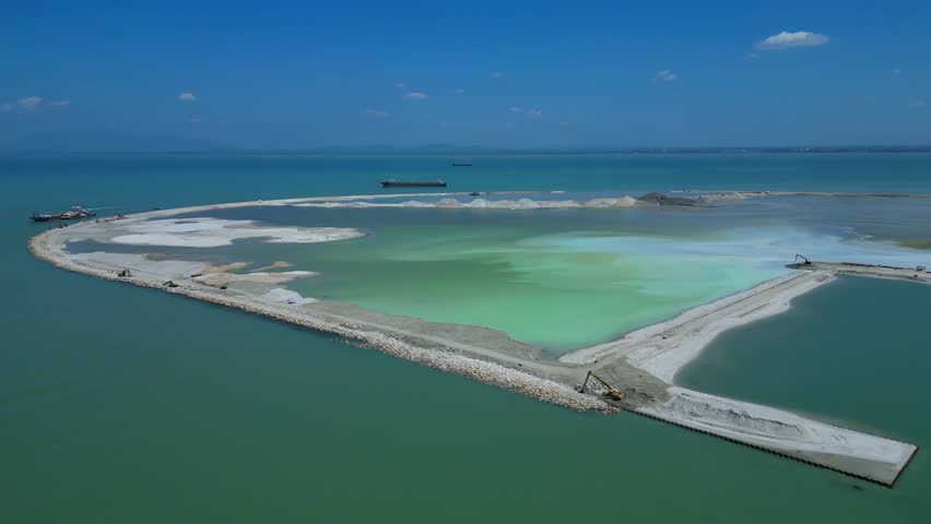 Penang land reclamation landscaping project building new artificial island development for urban expansion. Infrastructure work in progress. Magic aerial view static panorama hovering drone