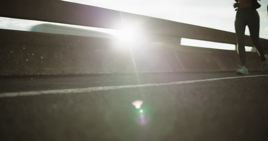 Legs, people and running in city for fitness, exercise and workout for wellness with friends. Road, shoes and runners training outdoor for health, cardio endurance and women jog together with flare