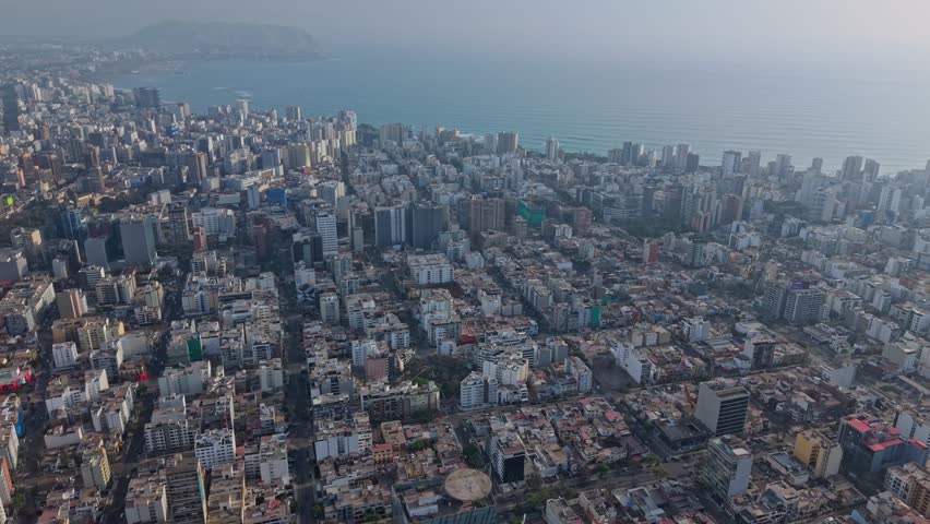 Aerial view of Lima cityscape with ocean, captured in serene calmness