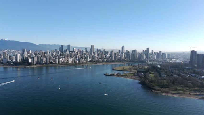 Sailboats At English Bay Near Kitsilano Beach With Downtown Vancouver Skyline In Canada. - aerial shot