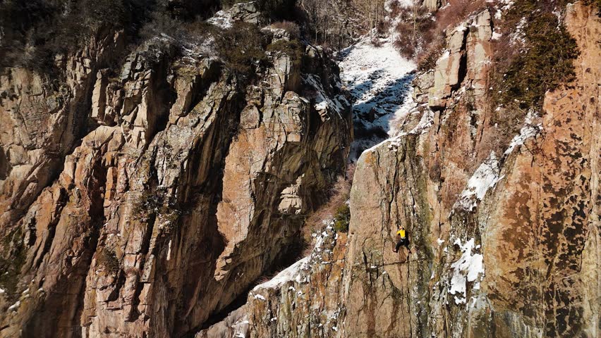 Mountaineer climbing at big glacier wall