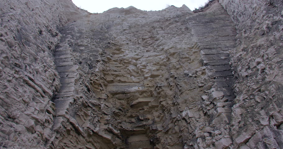 Mid shot Tilting down looking though the Kingsgate Arch chalk stack with Kingsgate bay in background.
