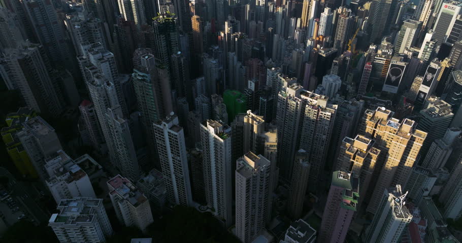 High-Angle Aerial View Of The Extremely Dense Cityscape Of Hong Kong With Towering Skyscrapers.