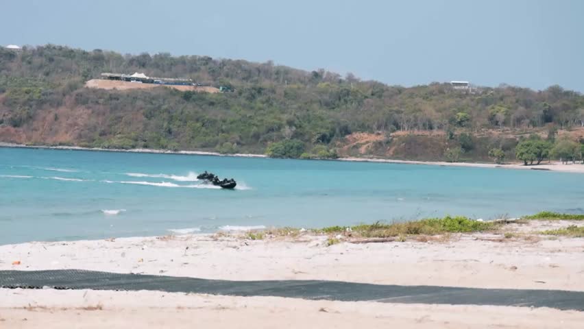 Troops from several countries and amphibious vehicles began to land.