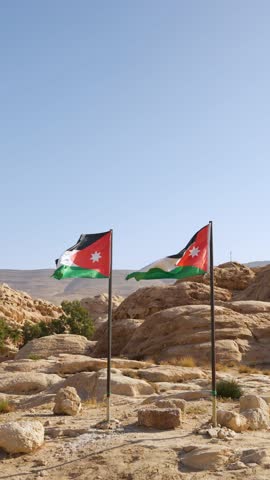 Jordan Flags Against Desert Rocks and Blue Sky. Vertical