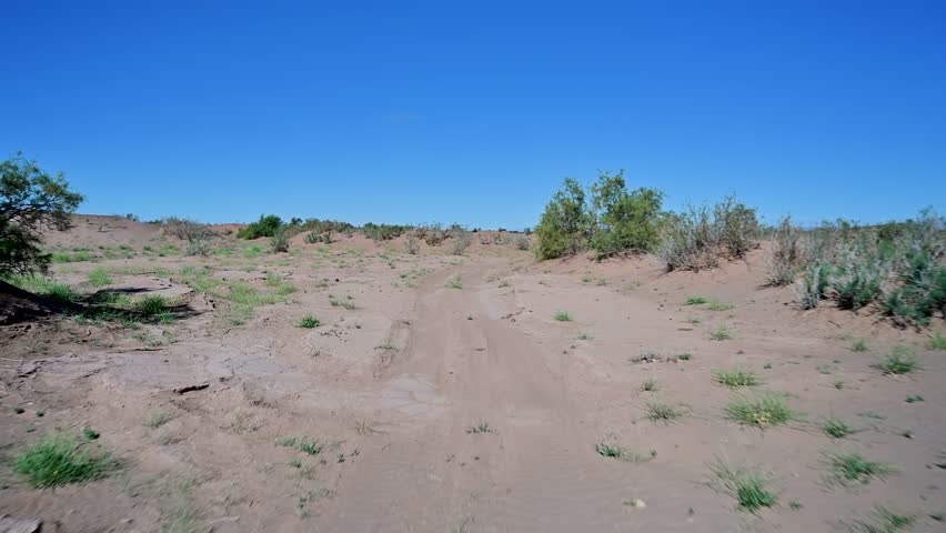 Off road safari adventure driving on a sandy track through the barren landscape of the Sahara desert in Morocco
