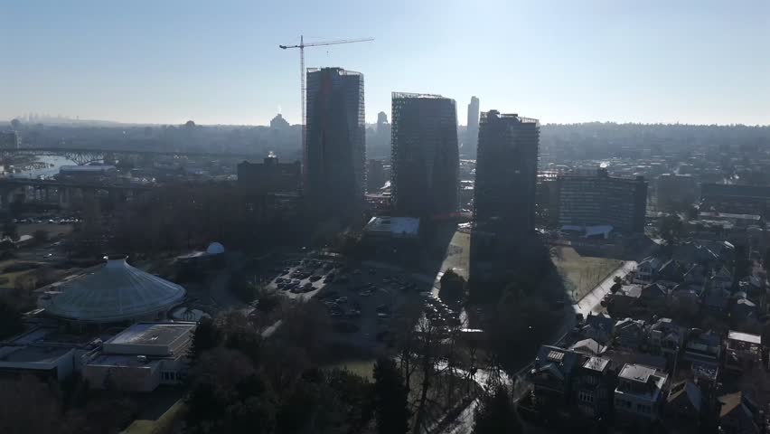 Silhouetted Three Towers Of Building Under Construction In Vancouver, Canada. - aerial shot