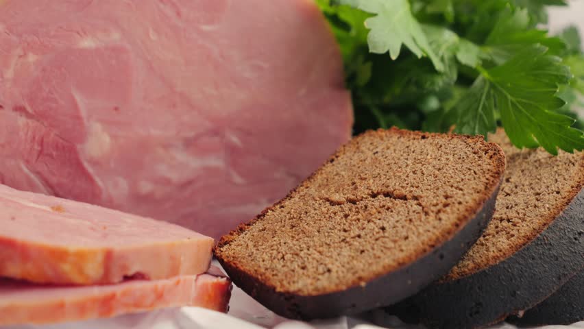 Farm ham with rye bread and parsley. Concept of healthy homemade breakfast.