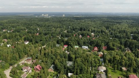 Aerial Vertical Rise over Wooded Village