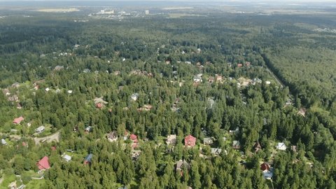 Drone Flying Forward Descending over Forest Village