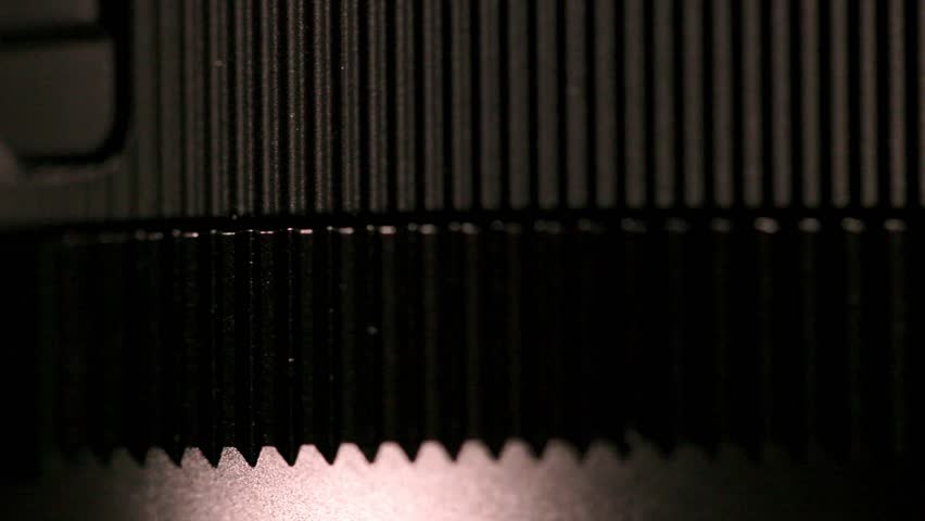 Macro shot of a lens aperture ring moving thru the f:1.4 marking and tick marks all the way to f:16 and Auto.