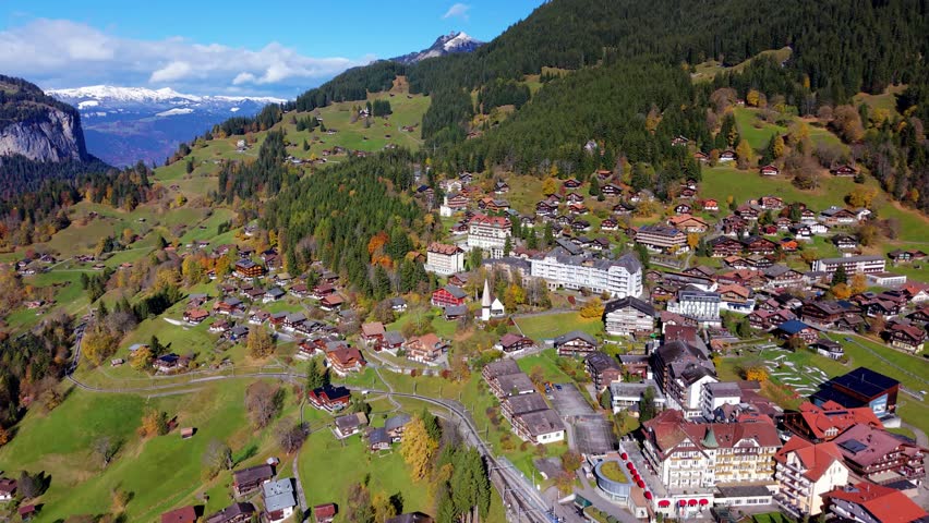 Wengen village aerial view situated on a mountain shelf with majestic alpine backdrop. Wengen, Canton of Bern, Switzerland