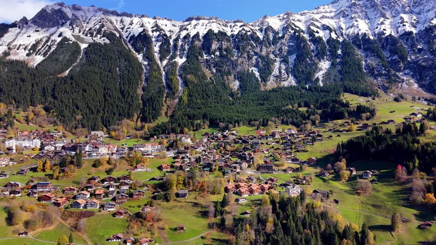 Wengen village aerial view situated on a mountain shelf with majestic alpine backdrop. Wengen, Canton of Bern, Switzerland