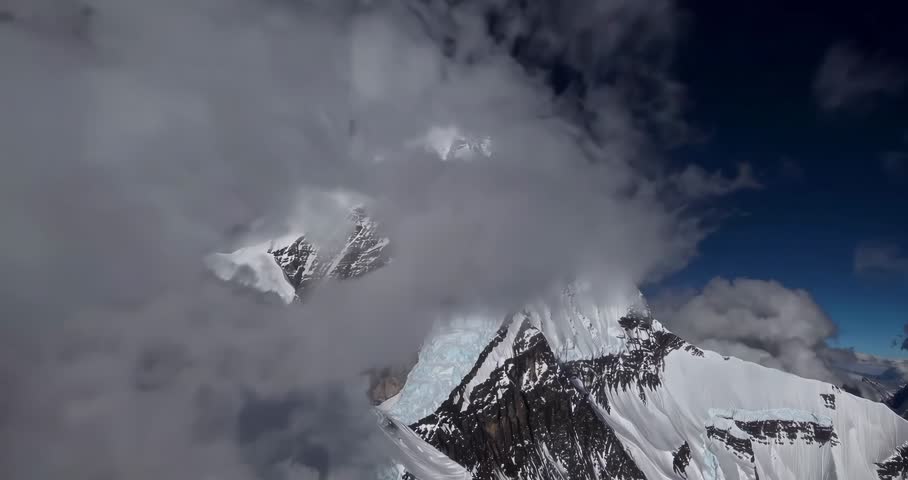 This video captures Mount Robson, the highest peak in the Canadian Rockies. The visual documents the 3,954-meter summit, featuring rock faces and snow accumulation within Mount Robson Provincial Park. The composition illustrates the terrestrial topography and mountain range geography in a high-resolution 4K format for use in geological, environmental, and regional documentary media.