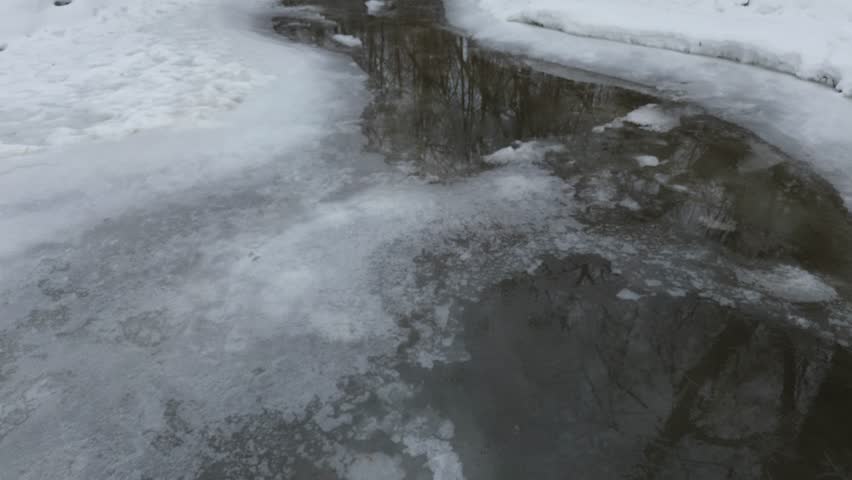 Frozen river in the winter forest. Beautiful winter landscape with frozen river. River in the winter forest. Winter landscape. Snow on the river. Quebec, Canada