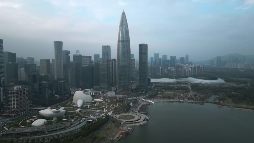 Panoramic aerial view of skyscrapers and Shenzhen Talent Park along the bay next to the Spring Bamboo China Resources Tower in downtown Shenzhen, China on a sunny day.