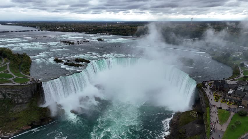 Experience the breathtaking beauty of Niagara Falls from above, with its powerful waters, misty atmosphere, and lush greenery. Perfect for travel and adventure content, Ontario, Canada