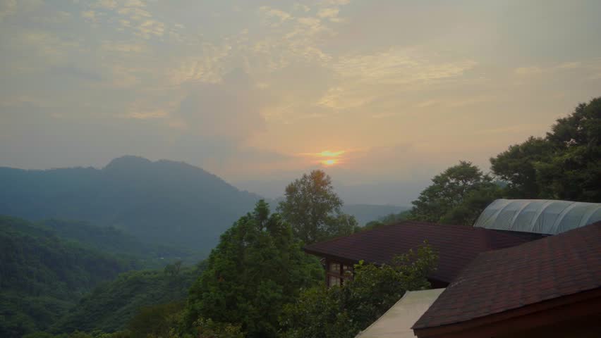 Sunset timelapse over mountain landscape in Miaoli, Taiwan with clouds and forest hills at dusk.