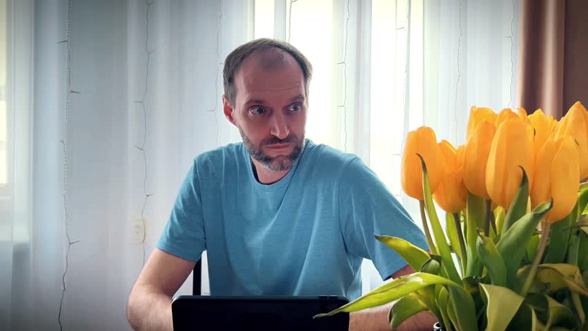 Mature man showing an "aha" moment or idea gesture while using a digital tablet at home. Ideal for educational content, software tutorials, and remote work marketing campaigns.