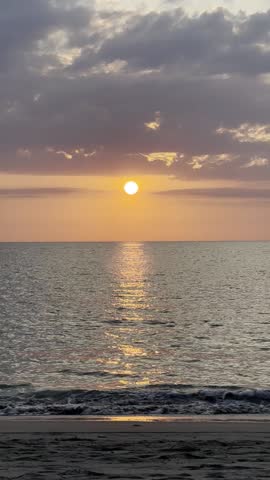 Serene Beach Sunset Over Ocean Waves
