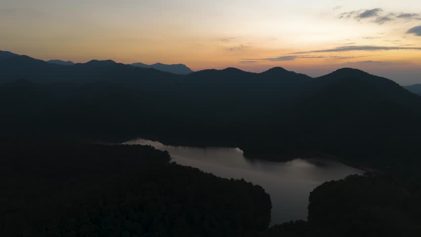 Fly over Mae Pha Haen Lake at evening, view of mountains and colorful sky