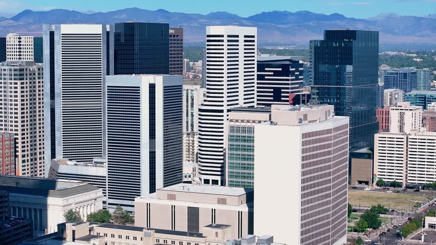 Panoramic drone telephoto establishing over downtown Denver at midday, Colorado USA