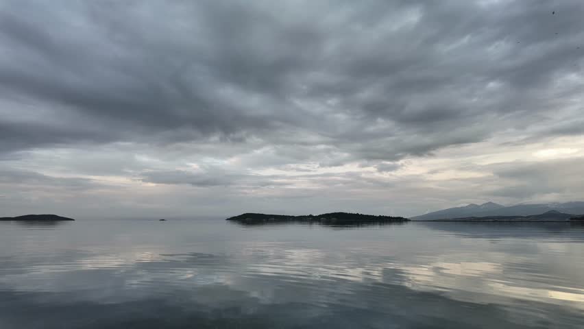 Dramatic Grey Clouds Moving Over Calm Coastal Landscape