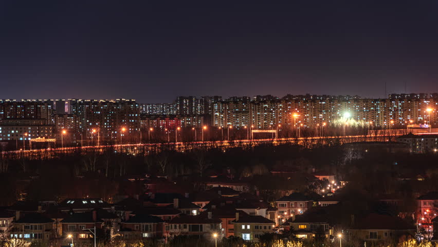 City lights and building silhouettes under the winter night sky