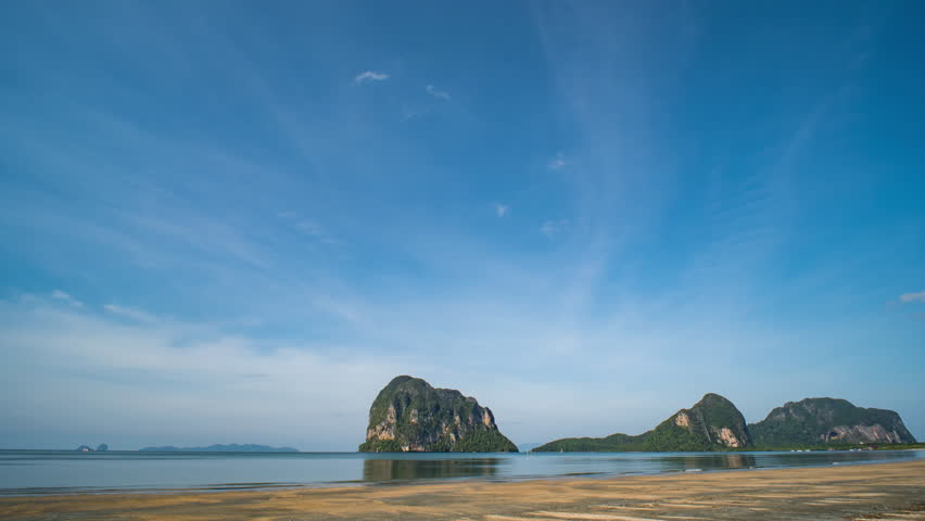 Relaxing time-lapse of a peaceful beach in Southern Thailand under a bright blue sky.