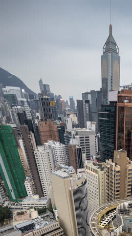timelapse of Hong Kong skyline from unique high vantage in vertical at sunset