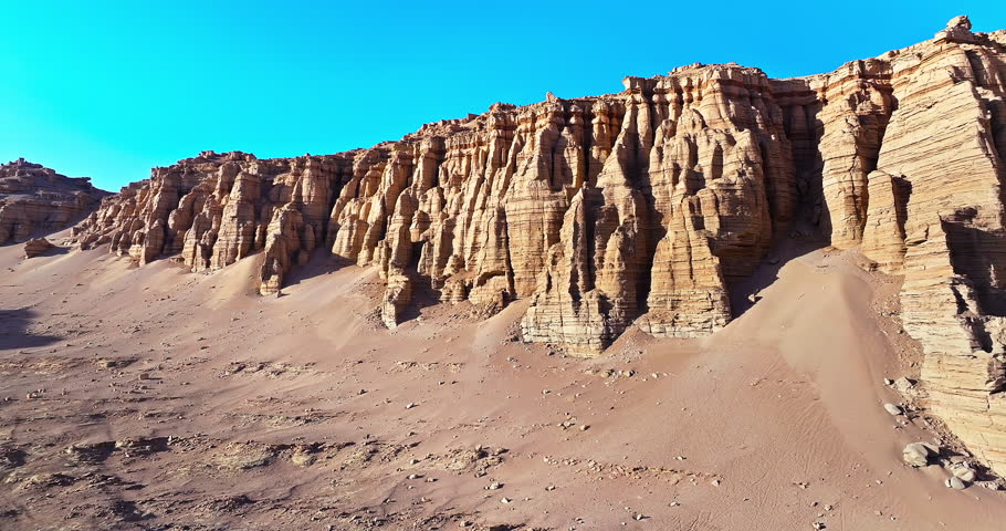 Scenic view of rugged Yardang geological formations and wind-eroded rocks in the Gobi Desert, Xinjiang, China.