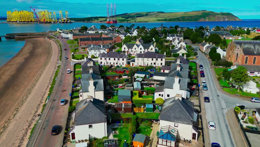 Aerial view of residential coastal homes in Nigg along the Cromarty Firth highlighting peaceful rural lifestyle and Scottish seaside living.