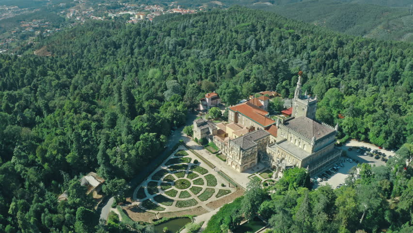 Aerial view of Bussaco Palace in Luso Portugal surrounded by lush green forest mountains garden showing historic architecture cultural heritage landmark famous travel destination in Europe traveling