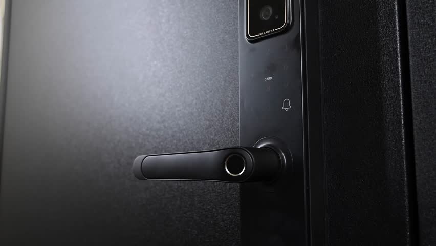 A woman opens a modern smart door lock using a contactless key.