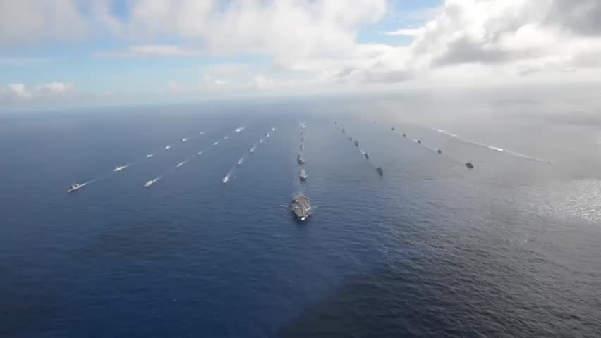 Aerial view of a fleet of warships participating in the Rim of the Pacific 2014 exercise, demonstrating naval coordination, power, and maritime strategy.