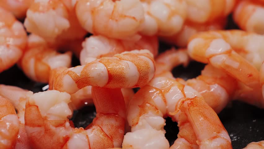 Close-up of shrimp fried in a pan.