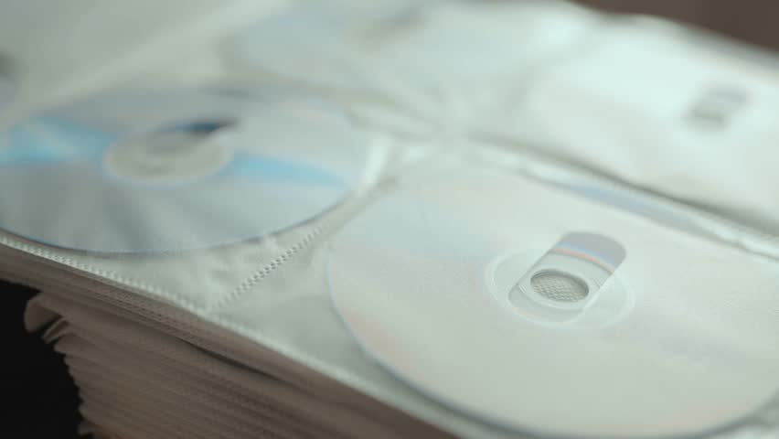 Collection of DVD and CD discs stored in a folder.