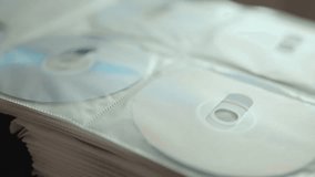 Collection of DVD and CD discs stored in a folder. - Powered by Shutterstock - Get 15% off with code: PIKWIZARD15