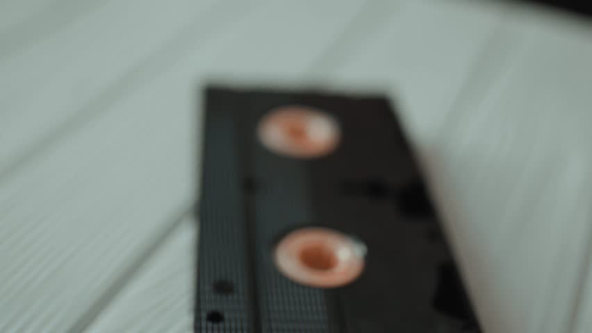 Stack of vintage VHS video cassettes with blank labels. Old analog media technology from 80s and 90s.