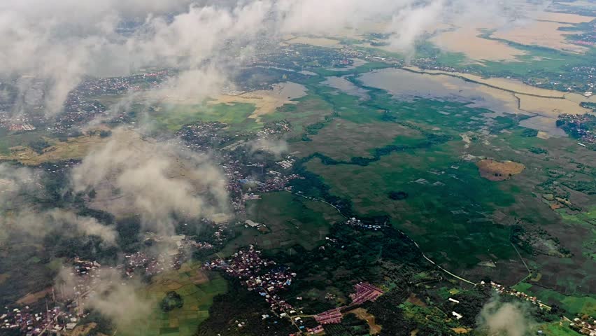 Top View of Countryside Farmland with Floating Clouds