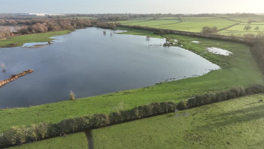 aerial view of flooded green fields and winter wetland at Stanwick Lakes nature reserve Northamptonshire England