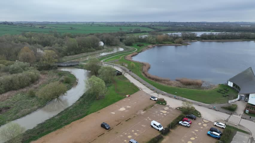 aerial drone view of large still lake at Stanwick Lakes nature reserve on calm overcast morning Northamptonshire