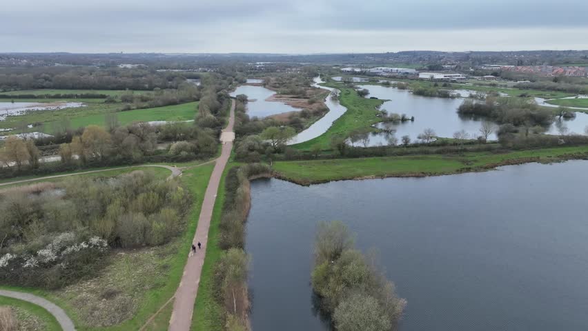high aerial drone view of Stanwick Lakes visitor centre area and surrounding wetland on overcast day England