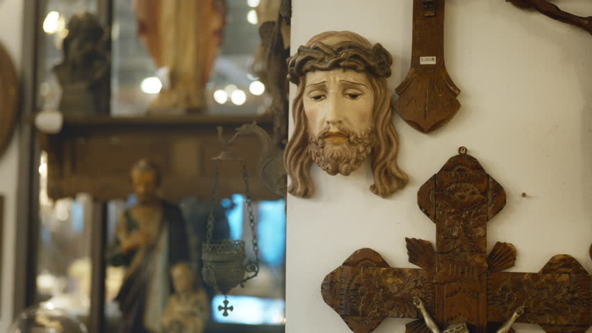 The wooden crucifixion of the Jеsus made by hands is in a dark room. Symbol of religion.