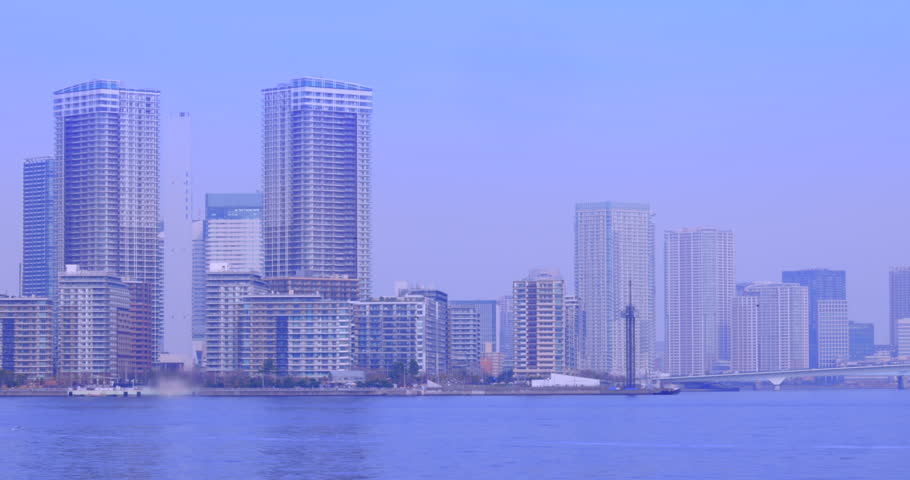 Towering apartment buildings and the blue sea on the waterfront of Tokyo Bay