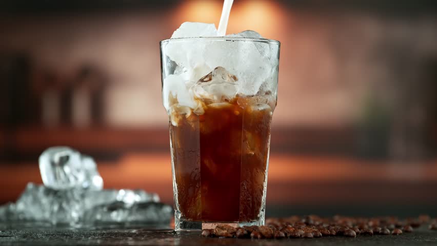 Super Slow Motion Shot of Pouring Milk into Ice Coffee , Filmed on High Speed Cinematic Camera