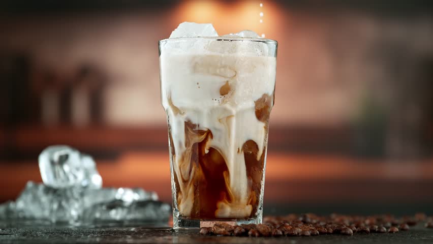 Super Slow Motion Shot of Pouring Milk into Ice Coffee , Filmed on High Speed Cinematic Camera