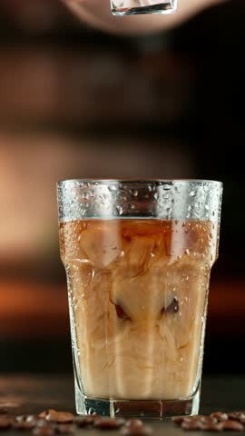 Super Slow Motion Shot of Pouring Milk into Ice Coffee , Camera Move, Filmed on High Speed Cinematic Camera